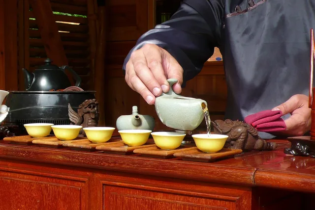 man, hands, tea, cups, pouring, porcelain, kettle, tea, tea, tea, tea, tea. Kiln evidence, no brands: porcelain, glaze, and what teaware shapes are for